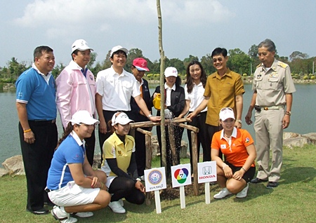 Golfers, sponsors and promoters pose for a commemorative photo during the tree planting event.